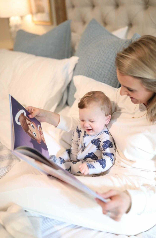 A mom and her son reading a personalized book by Hooray Heroes.