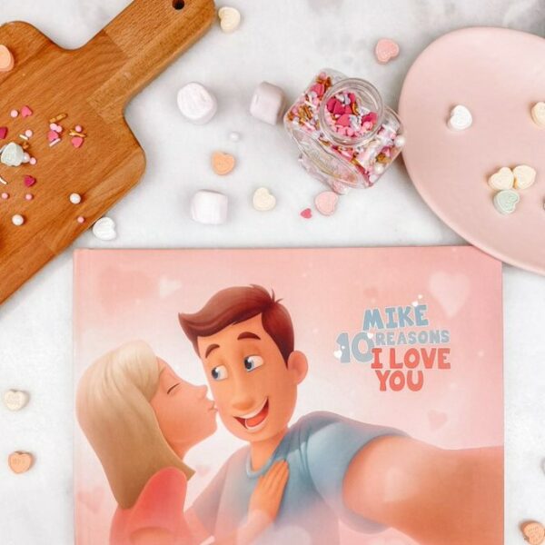 A Hooray Heroes personalized love book for couples, a cutting board and some Valentine's Day sweets.