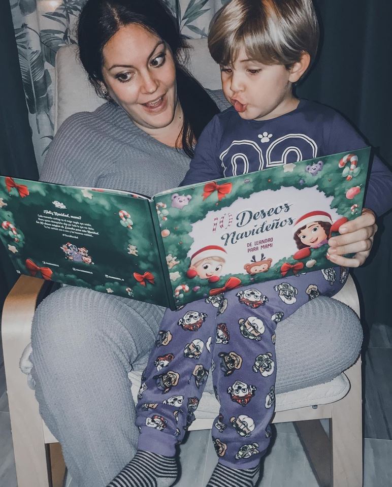 A boy named Leandro, reading a personalized book from Hooray Heroes with his mom.