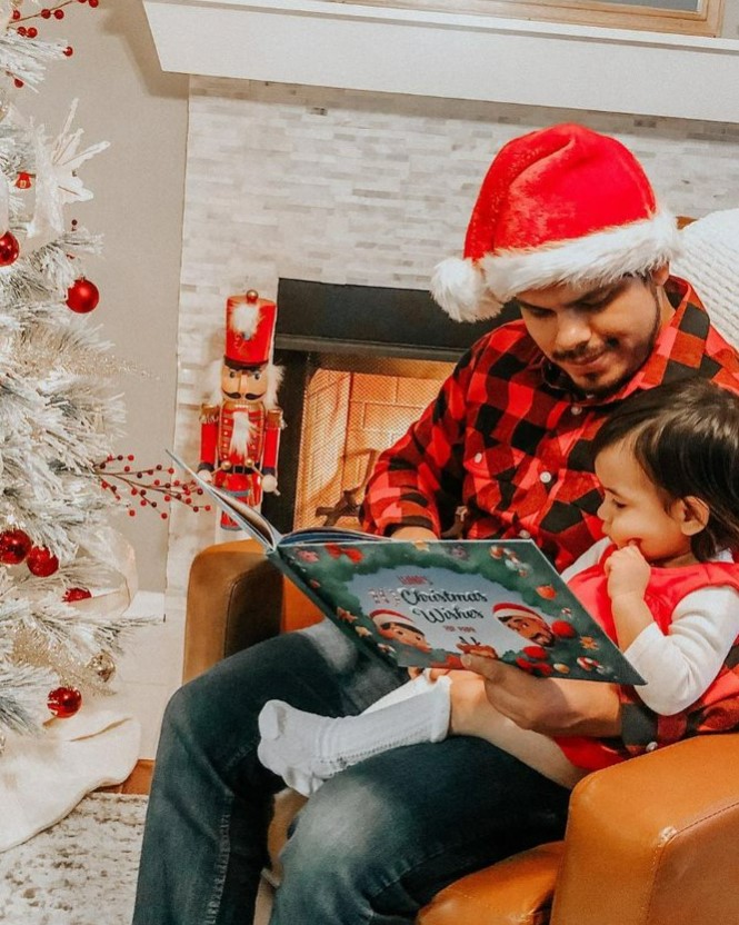 A father and child reading Hooray Heroes Christmas book for daddy and 1 kid.