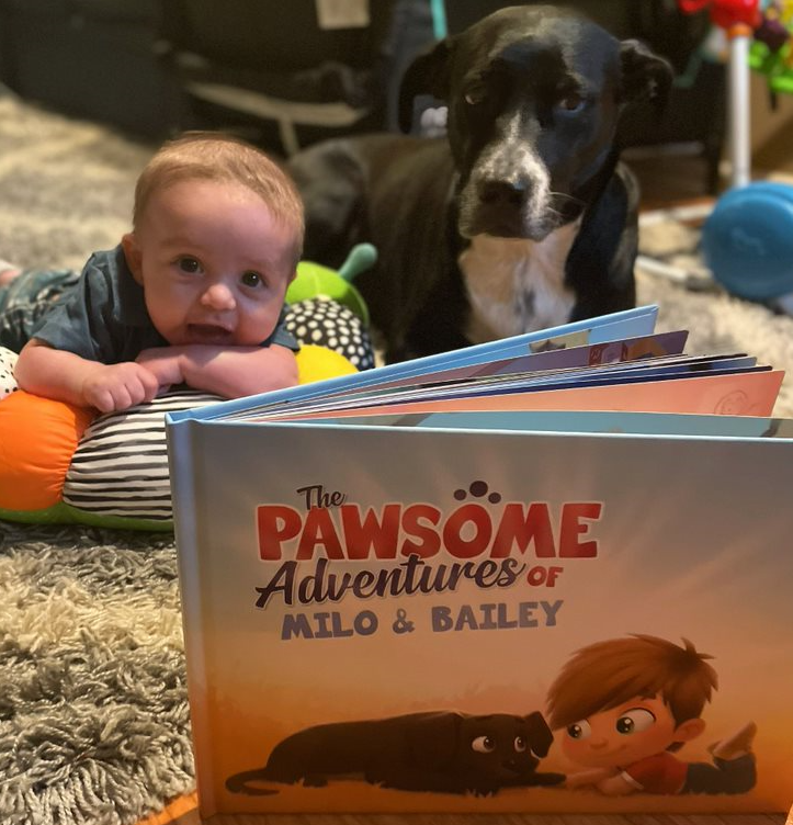 A little boy and his dog with a personalized book for pets and kids from Hooray Heroes.