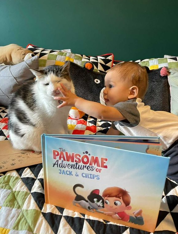 A little boy and his cat with a personalized book for pets and kids from Hooray Heroes.