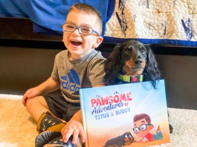 A little boy and his dog with a personalized book for pets and kids from Hooray Heroes.
