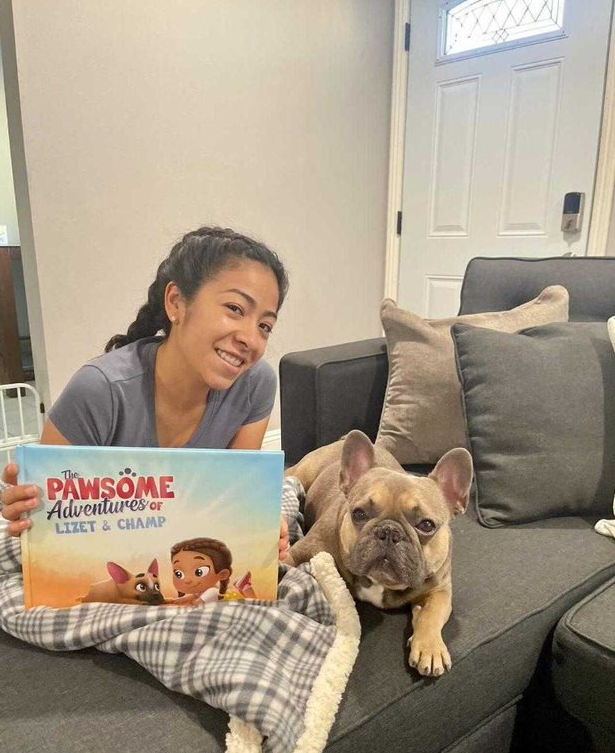 A woman and her dog with a personalized book for pets and owners from Hooray Heroes.