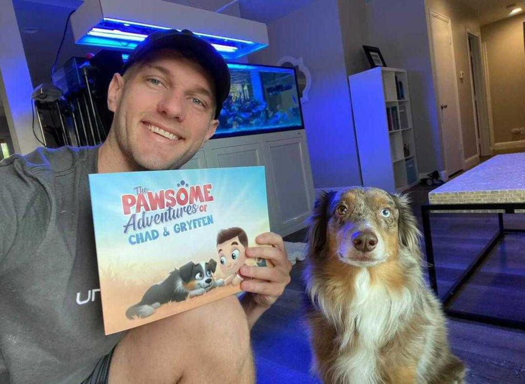 A man and his dog with a personalized book for pets and owners from Hooray Heroes.