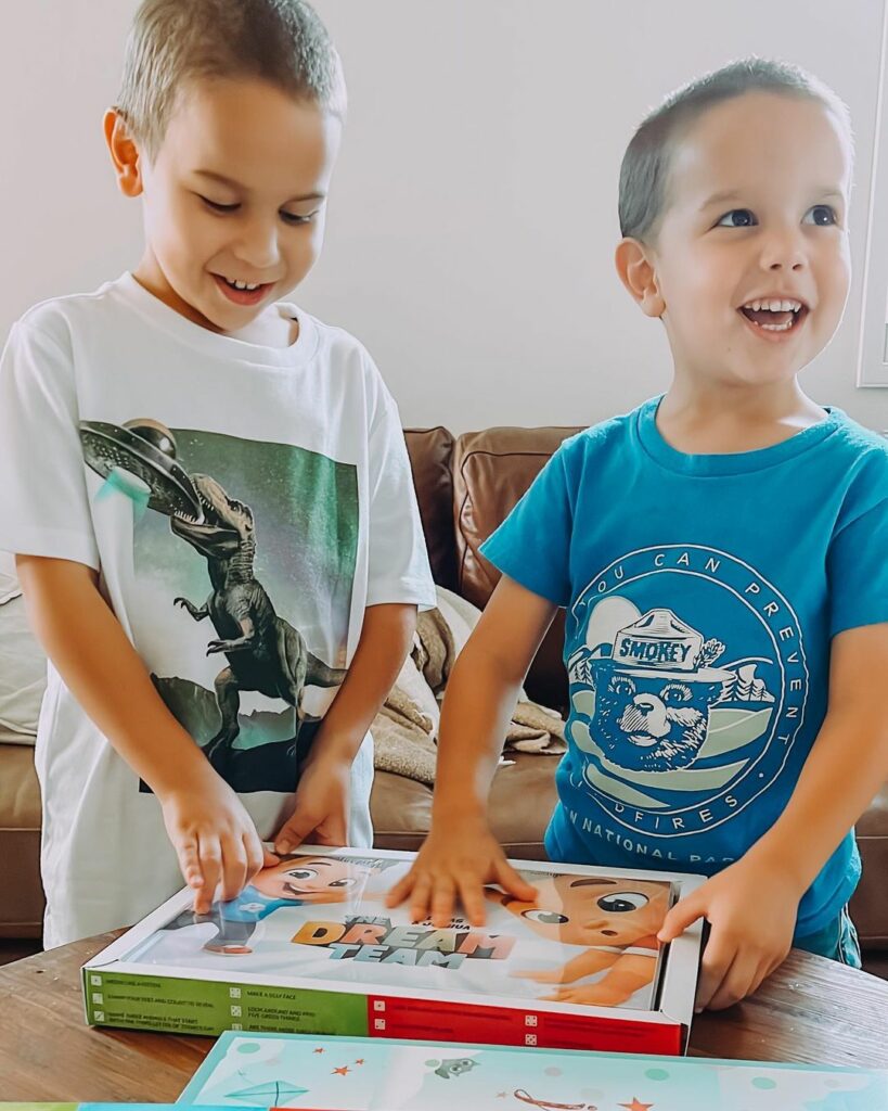 Two little boys with Hooray Heroes' newest book for siblings