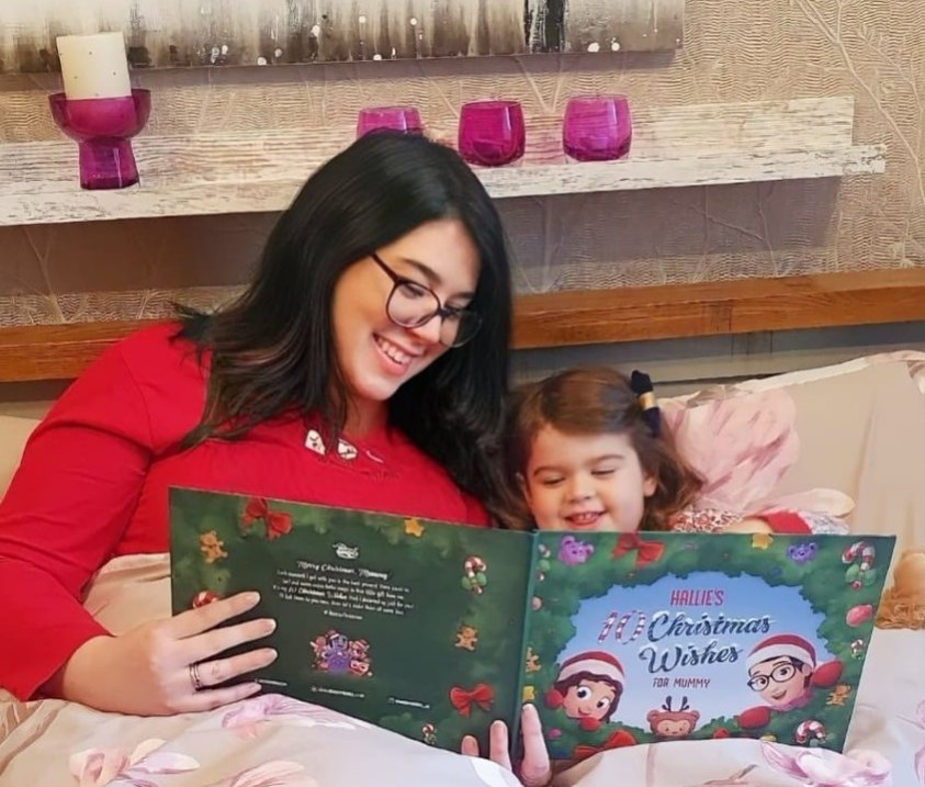 A mother and child read a Hooray Heroes custom Christmas book.