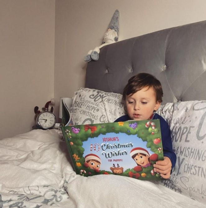 A child reads a one-of-a-kind DIY Xmas book from Hooray Heroes.