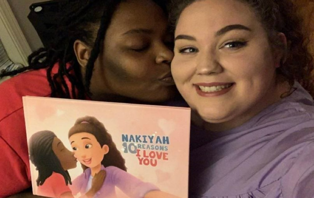 Couples bonding over a custom love book for same-sex couples.