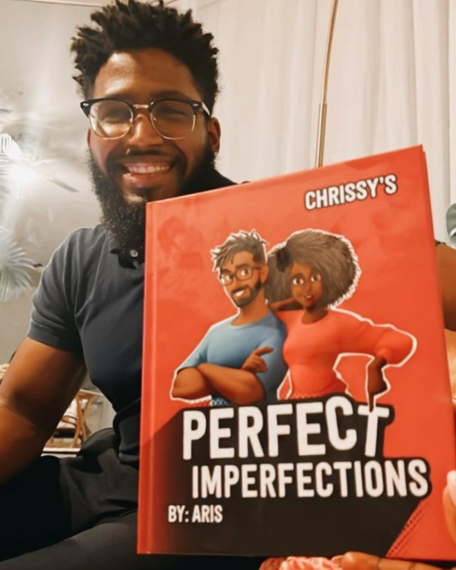 A man holding a personalised meme-inspired book for couples. 