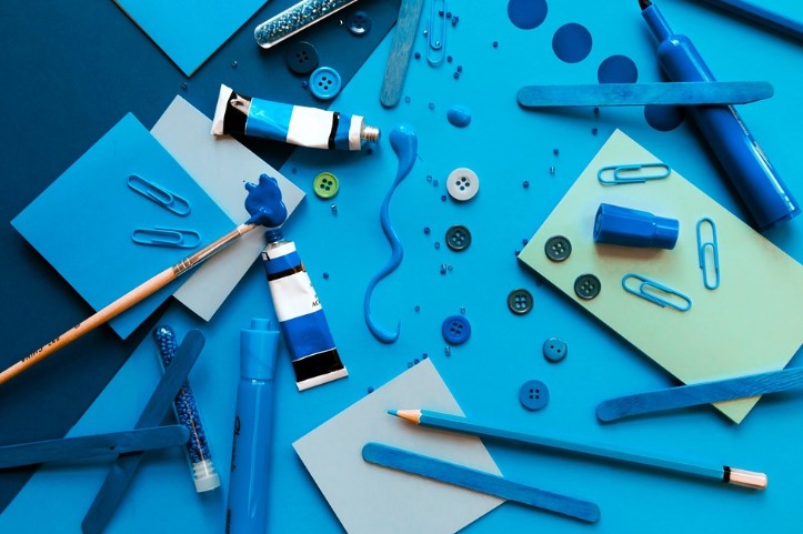 Lots of blue items used in craft or hobby projects on a blue background.