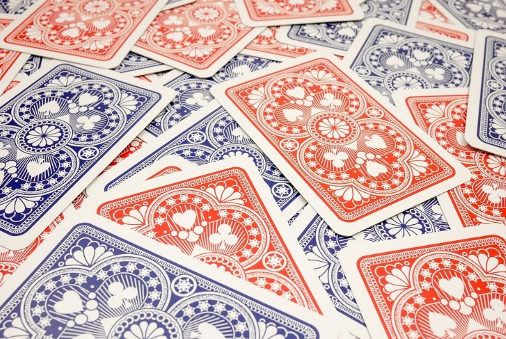 A number of red and blue playing cards laying face down. 
